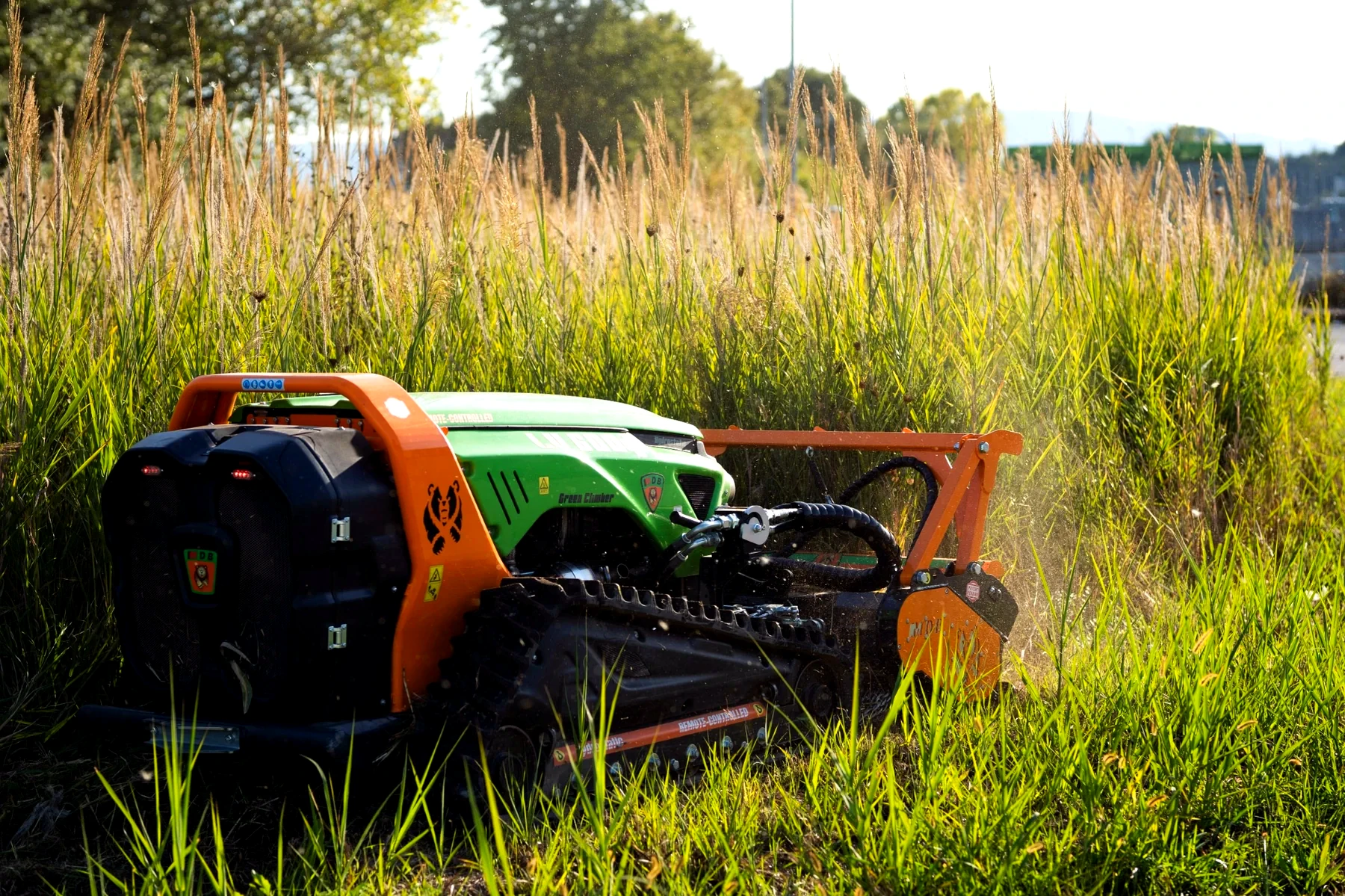 Remote tracked mower working in tall vegetation